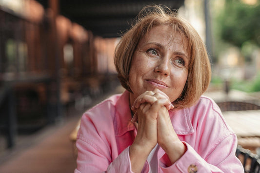 Relaxed woman with glowing skin representing perimenopausal skincare support
