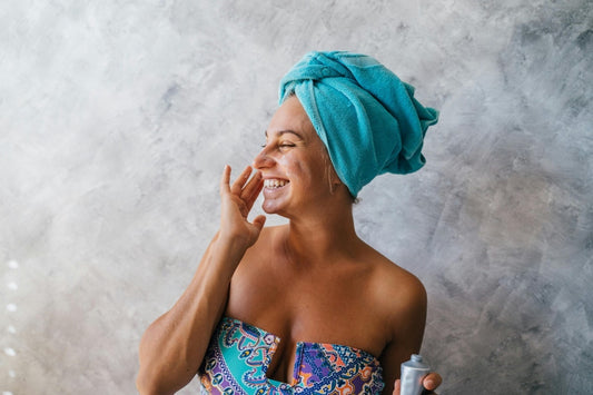 Smiling mature woman with glowing, youthful skin after non-invasive microcurrent and radiofrequency facial treatments at Sculpted Skincare in Essex, Hertfordshire and Cambridgeshire.